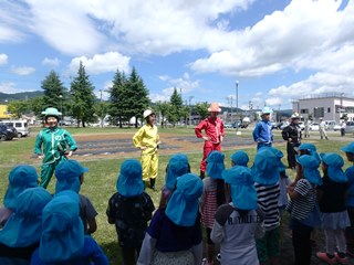 園児の前でポーズを決める地球泉隊のーりんジャーの画像